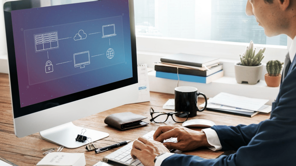 A suited man using a PDF page splitter on his computer.